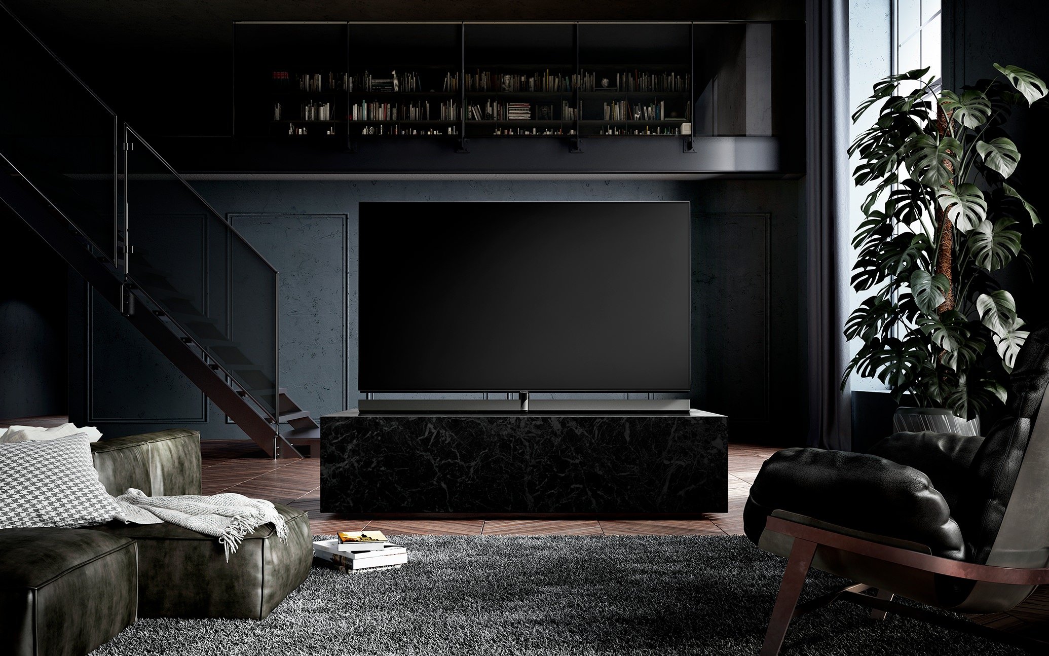 A modern living room with a large TV on a black marble stand, a dark sofa, a black armchair, a bookshelf above, and a tall leafy plant near a window.