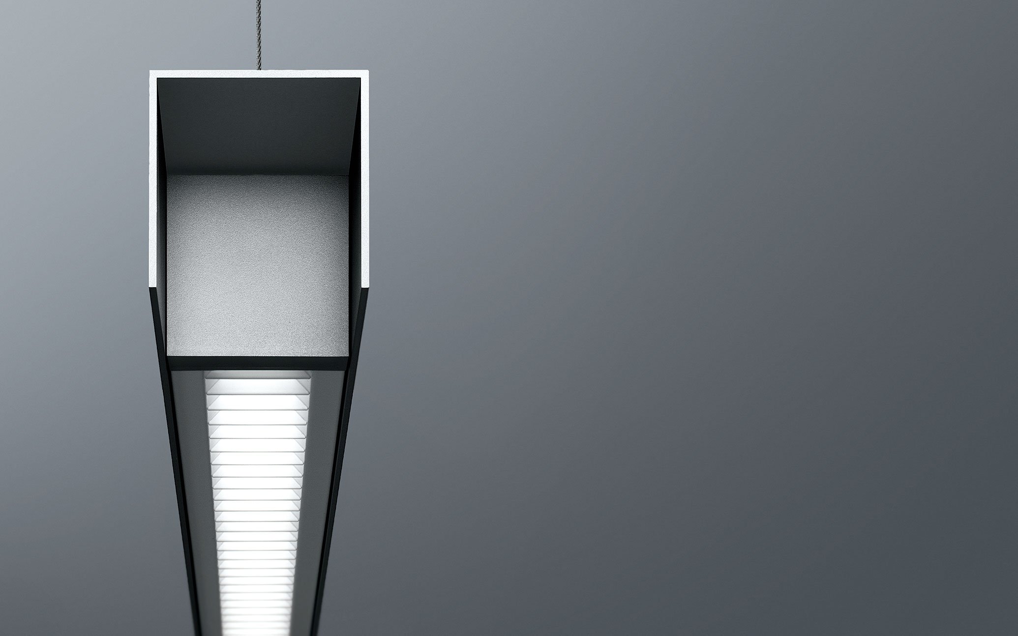 Close-up of a hanging ceiling light fixture with illuminated internal lighting and top view