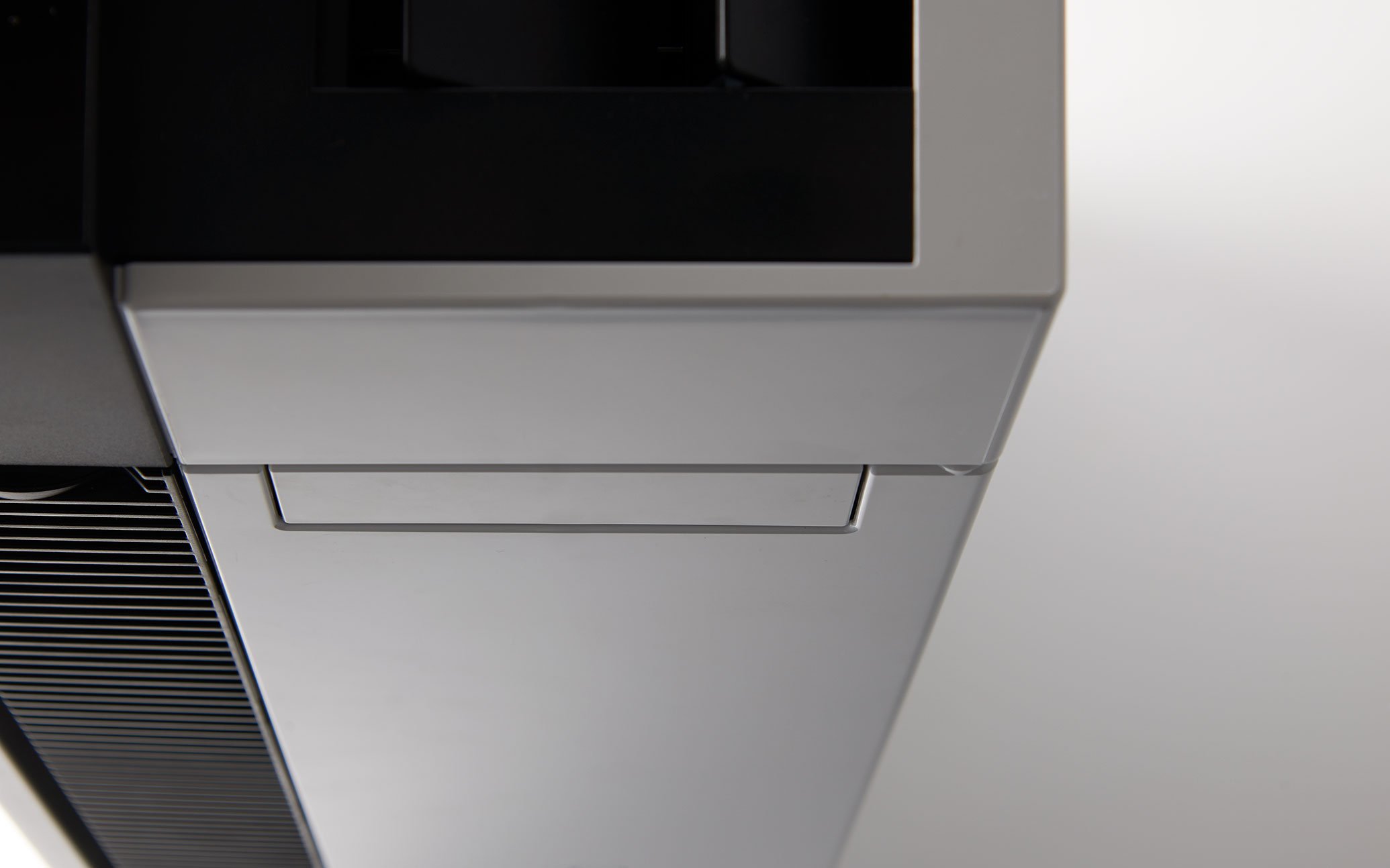 Side view of the ziaino from above, featuring a simple shape with black and silver panels arranged on the surface