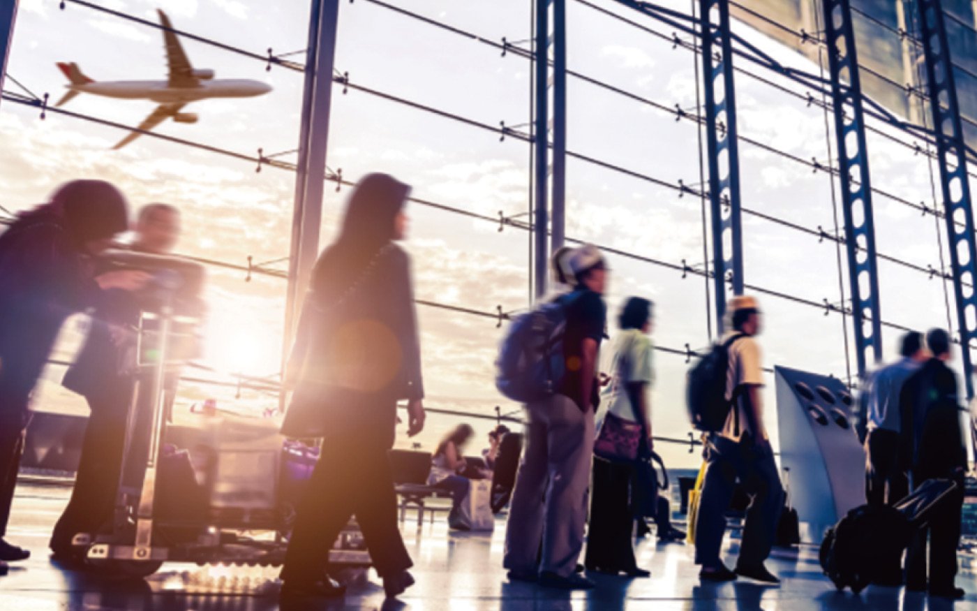 Travelers lined up in the airport departure lobby, carrying luggage, waiting in line towards the airplane, with airplane and sky visible through glass windows
