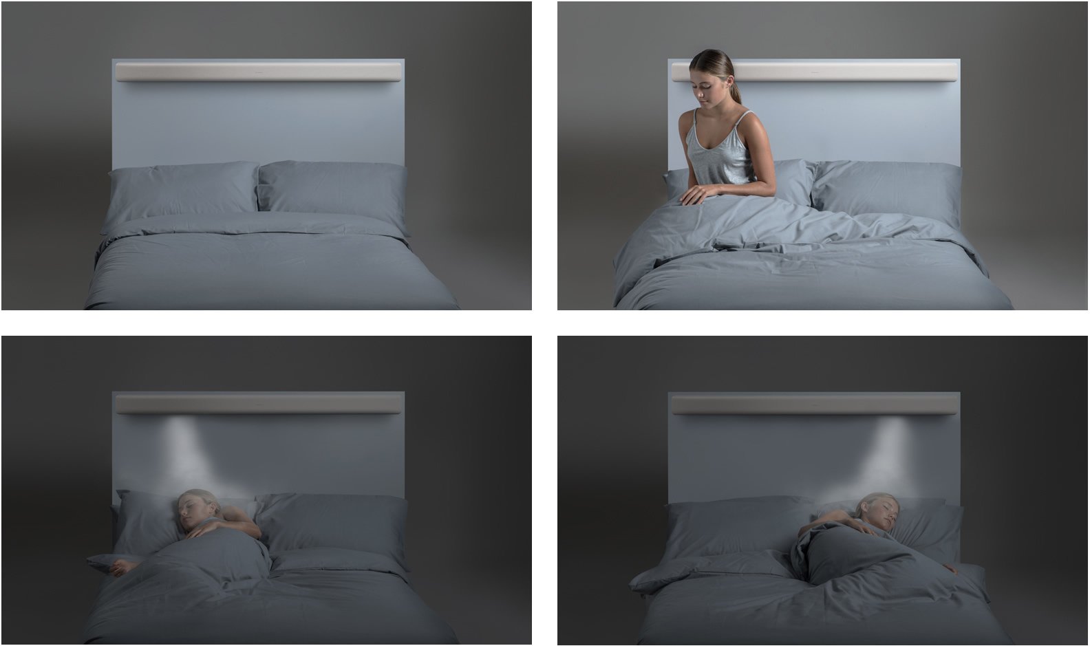 A person lying in a bed with gray bedding. A simple bedroom featuring a headboard with lighting above.