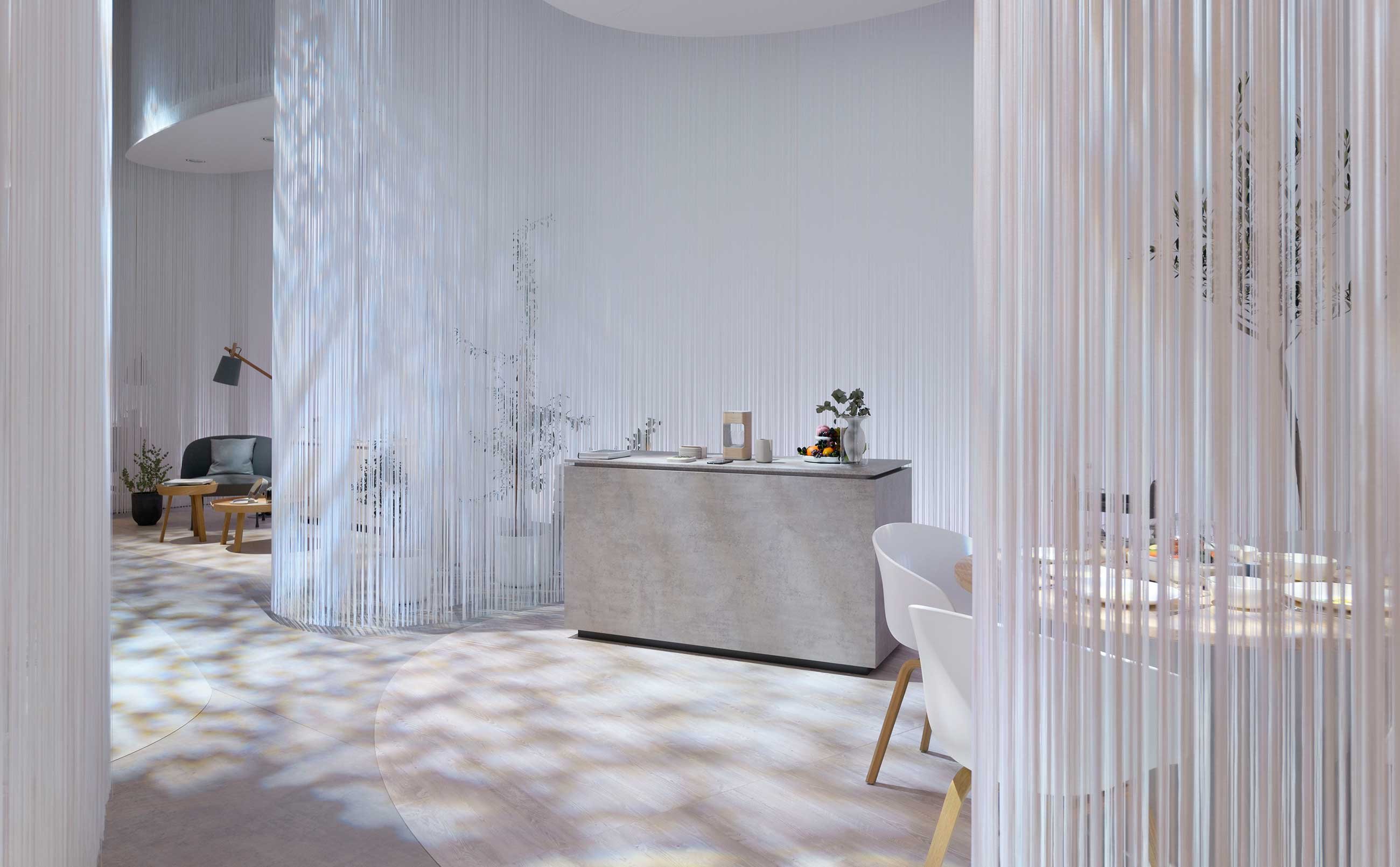 Kitchen counter dining table surrounded by white sliding curtains.