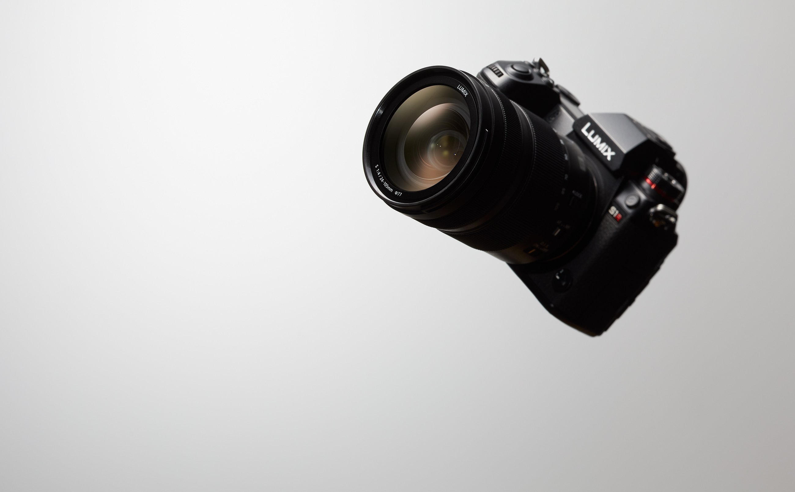SLR camera floating in the top right-hand corner.