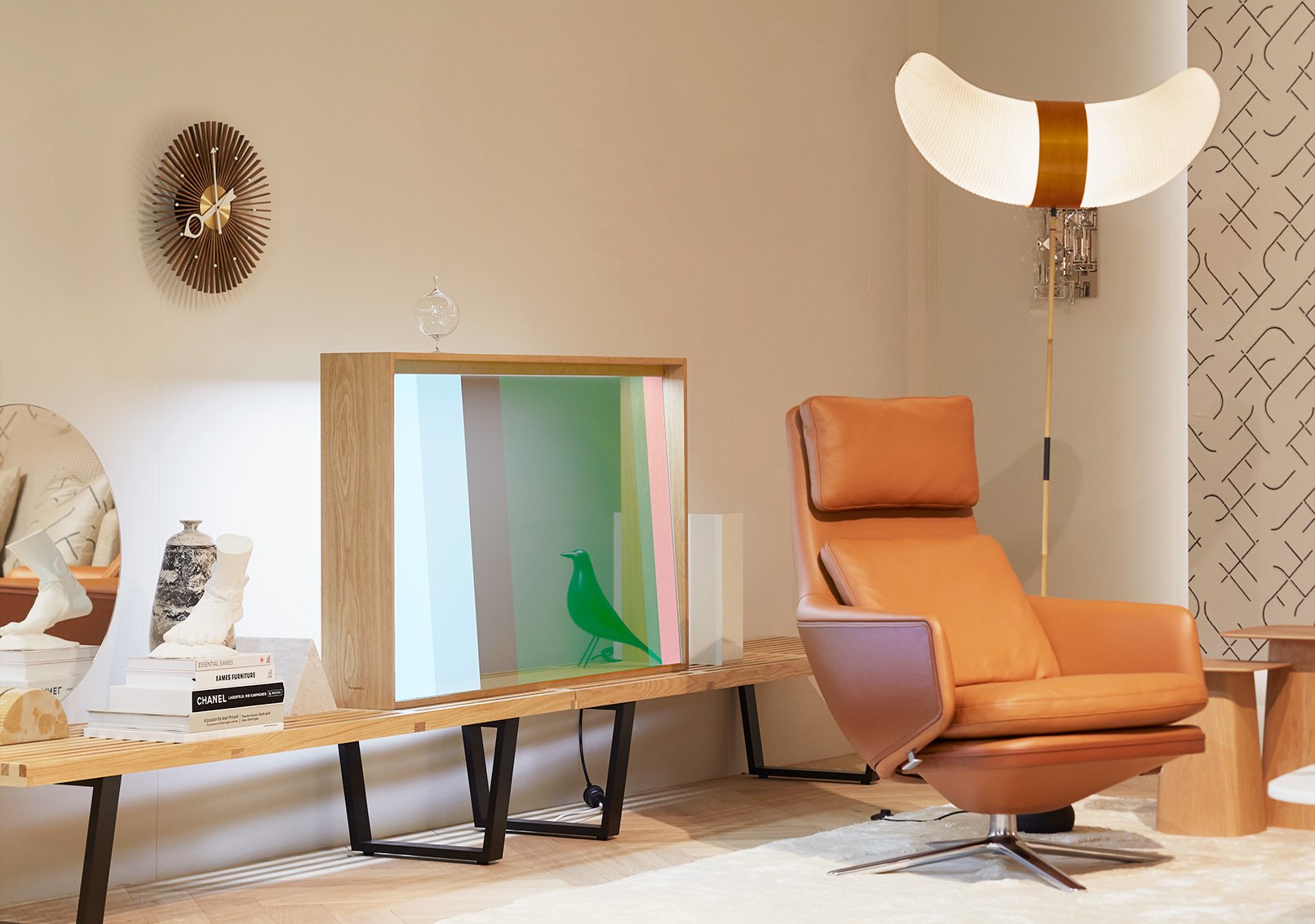 Wooden frame transparent display and brown recliner chair, moon-shaped ceiling lamp, round wall clock, shelf with decor on side