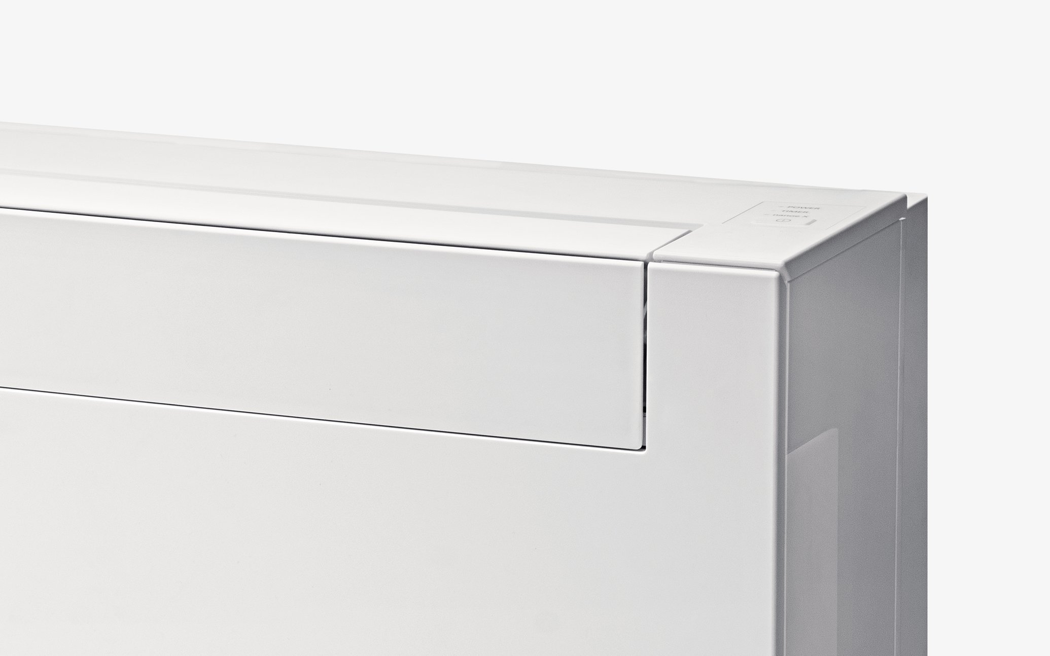 Close-up of a white floor-standing air conditioner seen from the front and side