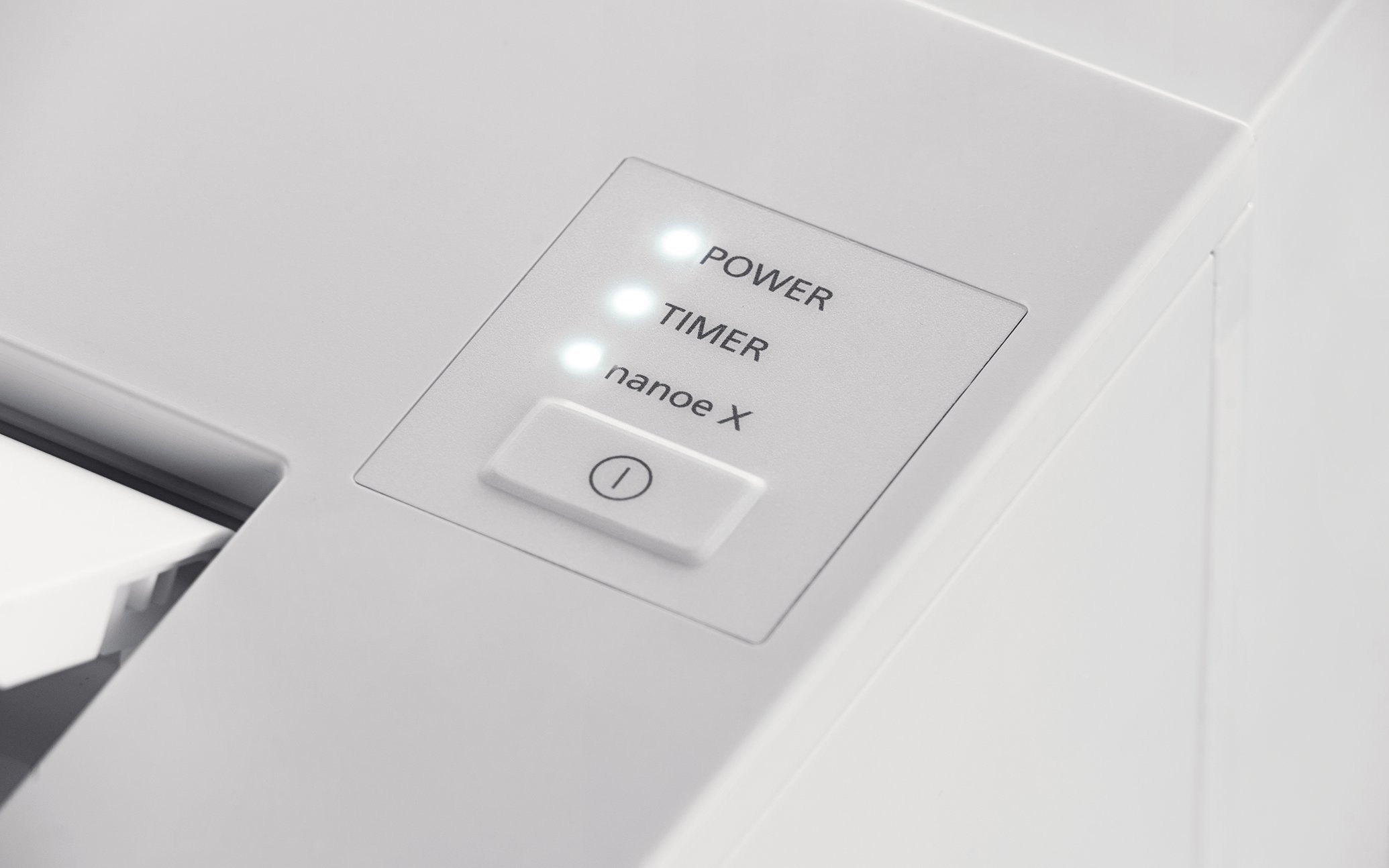 Control panel and LED indicator area of a white floor-standing air conditioner