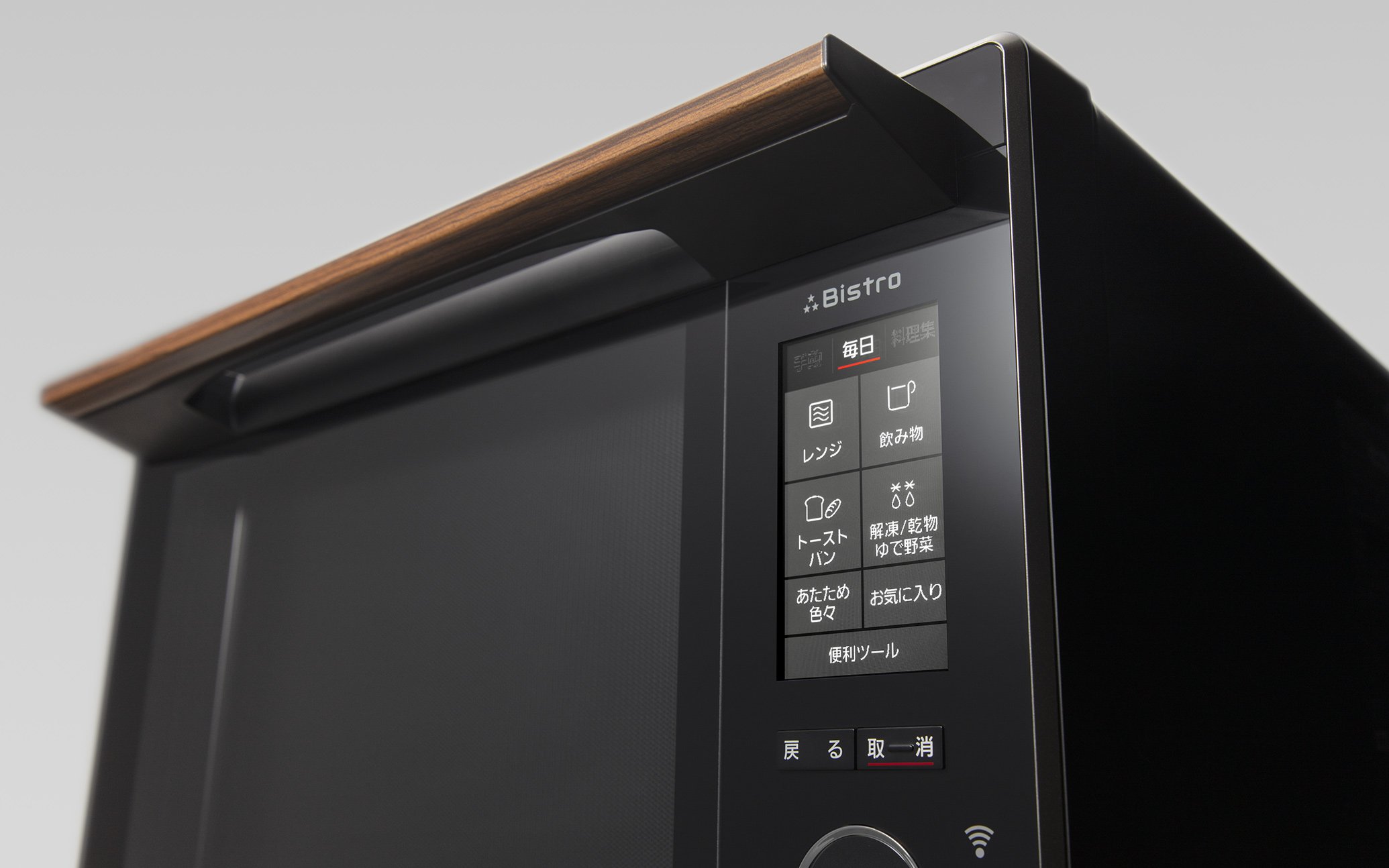 Front view of a black oven microwave with a wood grain handle and a touch panel control screen.