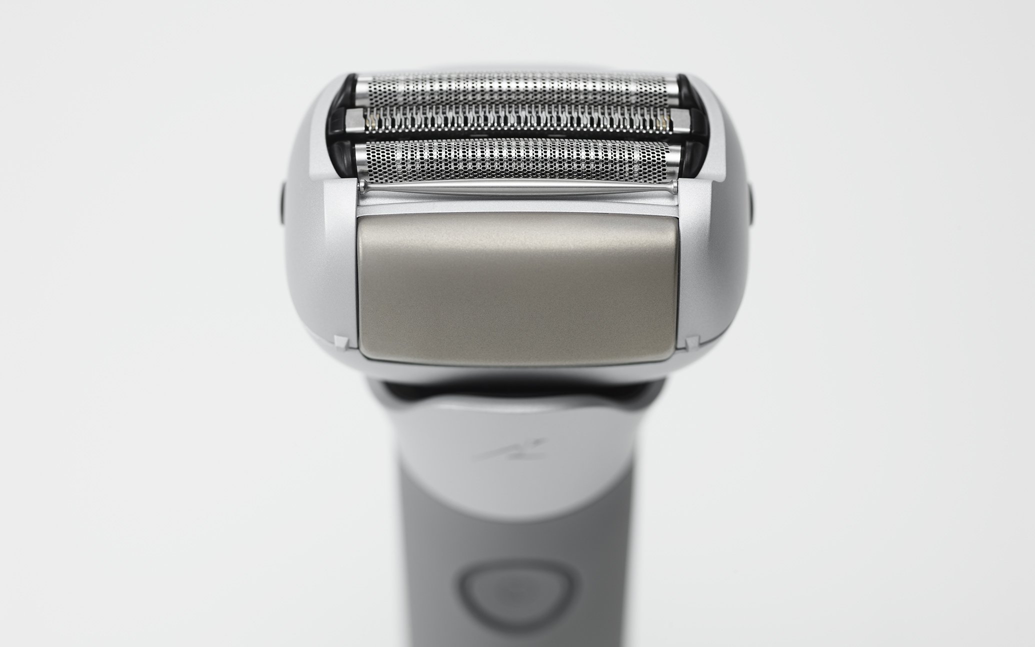 Front view of a silver and black electric shaver