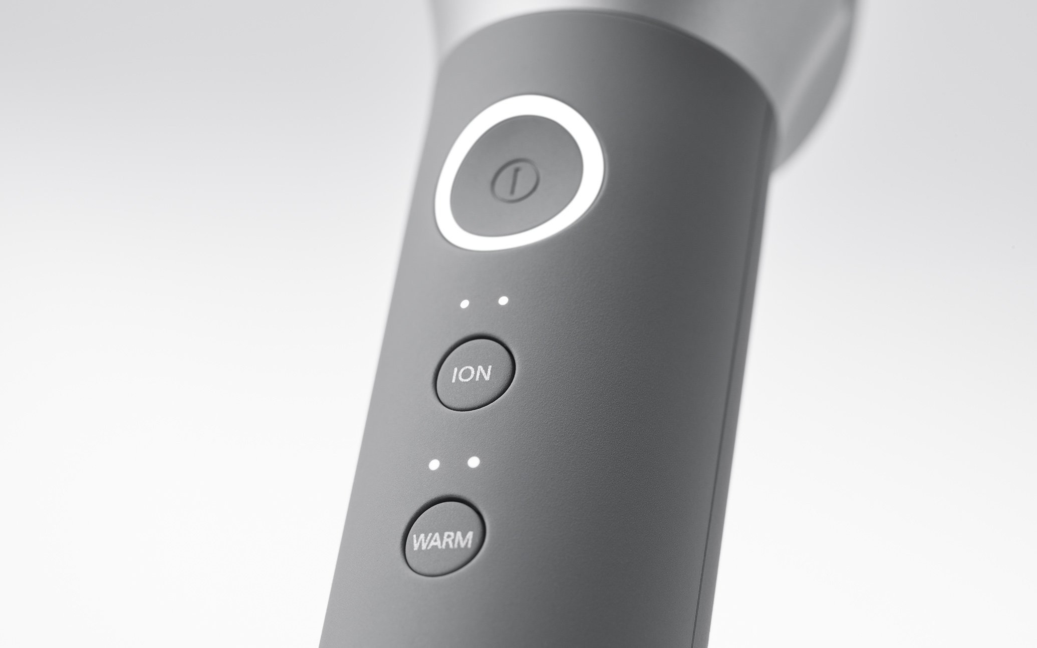 Front view of a shaver's control panel with round buttons and LED indicators