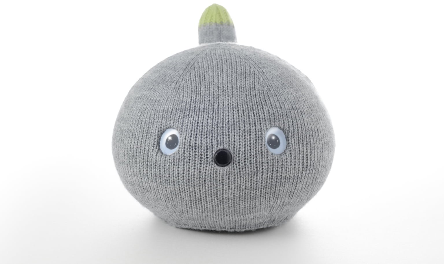 Round knitted animal-shaped plush toy, featuring eyes, nose, and a tail
